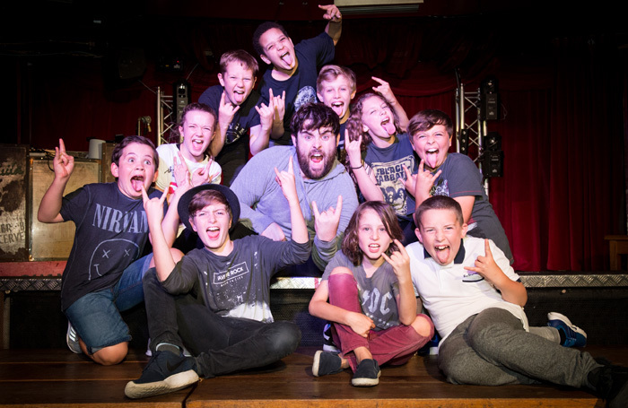 David Fynn with the young cast of School of Rock. Photo: Craig Sugden
