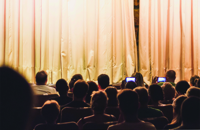 Audiences are increasingly using mobile phones once the curtain is up. Photo: Shutterstock