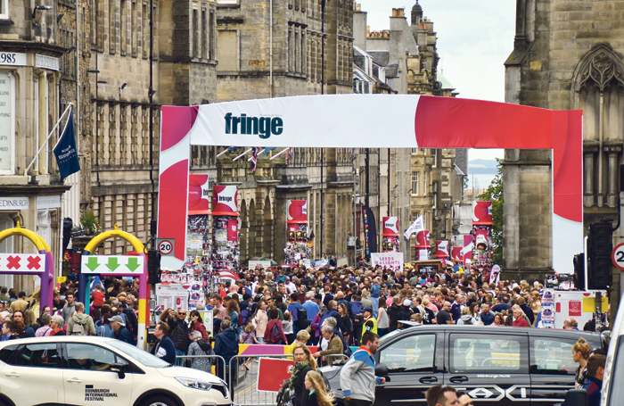 Festivalgoers throng the Royal Mile at the Edinburgh Festival Fringe. Photo: Lou Armor/Shutterstock