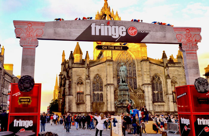 The Royal Mile with St Giles Cathedral in the background during the 2018 Edinburgh Festival Fringe. Photo: Lou Armor/Shutterstock