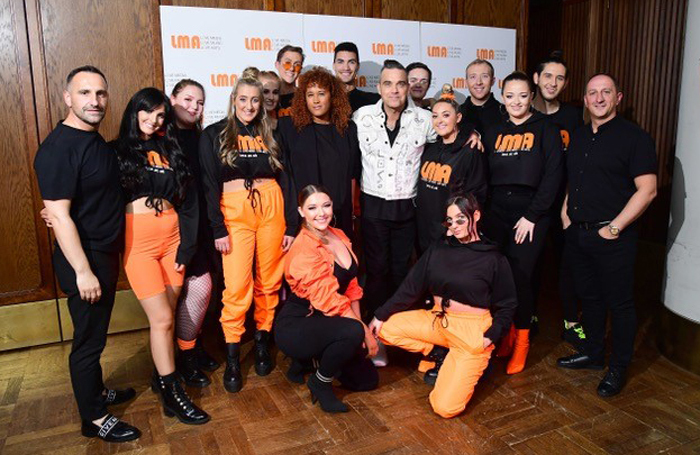 Robbie Williams and the LMA Choir. Photo: Ian West