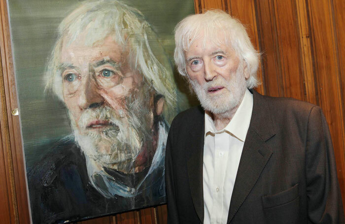 Tom MacIntyre beside his portrait by Colin Davidson in the Abbey Theatre. Photo: Brian McEvoy