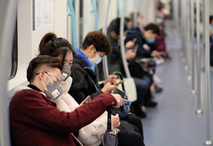 People wearing surgical masks on the subway in Shanghai. Photo: Shutterstock