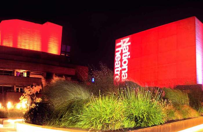 National Theatre, London, lit up in red