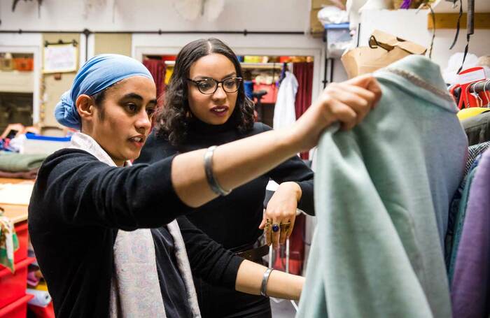 Members of a design team discuss a garment in the costume room of a theatre. Photo: Alex Brenner/Tiata Fahodzi
