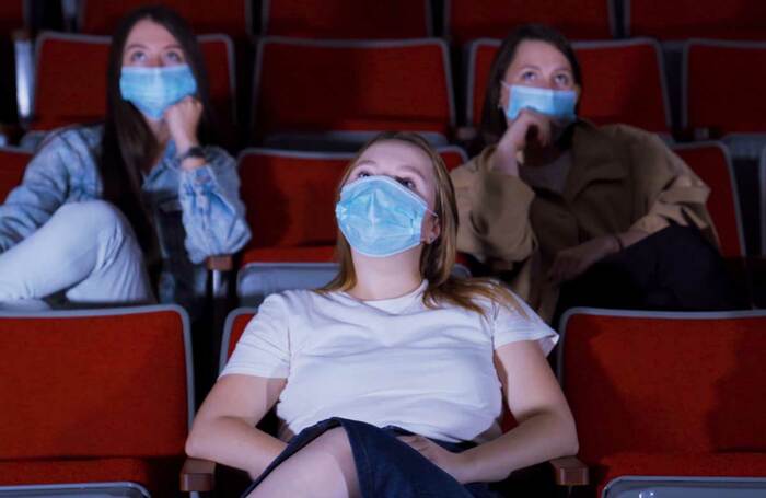 Audience members wear facemasks. Photo: Shutterstock