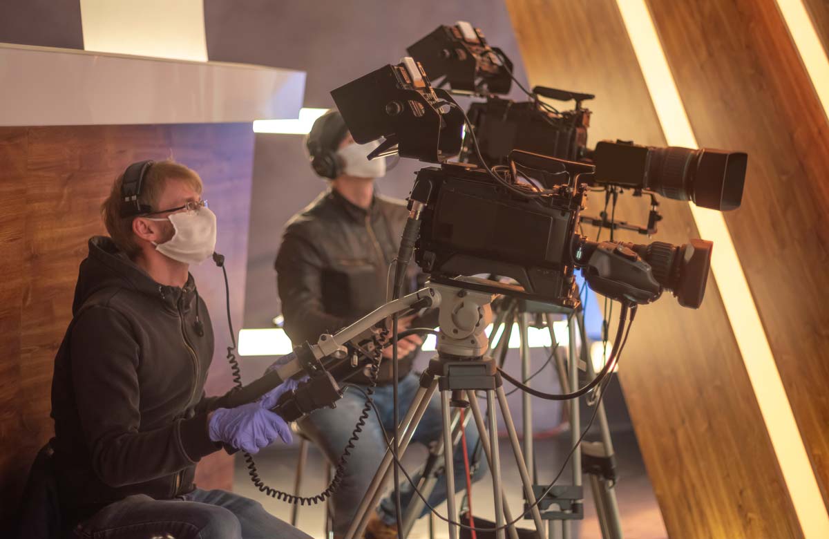 Camera operators on set wearing masks. Photo: Shutterstock