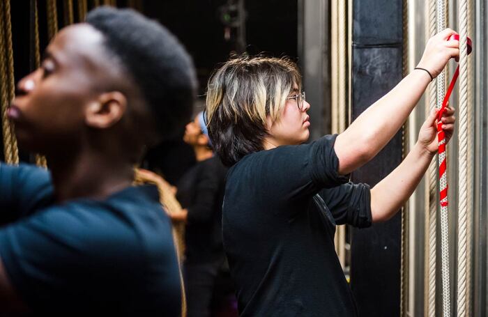  A theatre technician uses tape to mark a lift line to indicate the correct position for flying the attached bar. Photo: Alex Brenner/tiata fahodzi