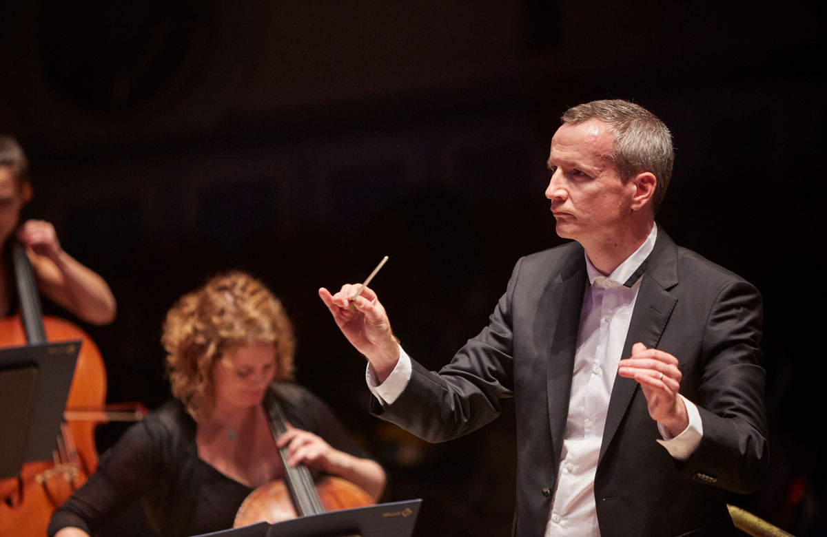 Opera North's music director Garry Walker conducting the company's orchestra