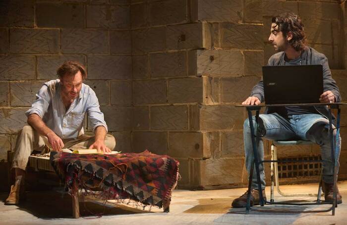 Daniel Lapaine and Scott Karim in The Invisible Hand at the Kiln Theatre, London